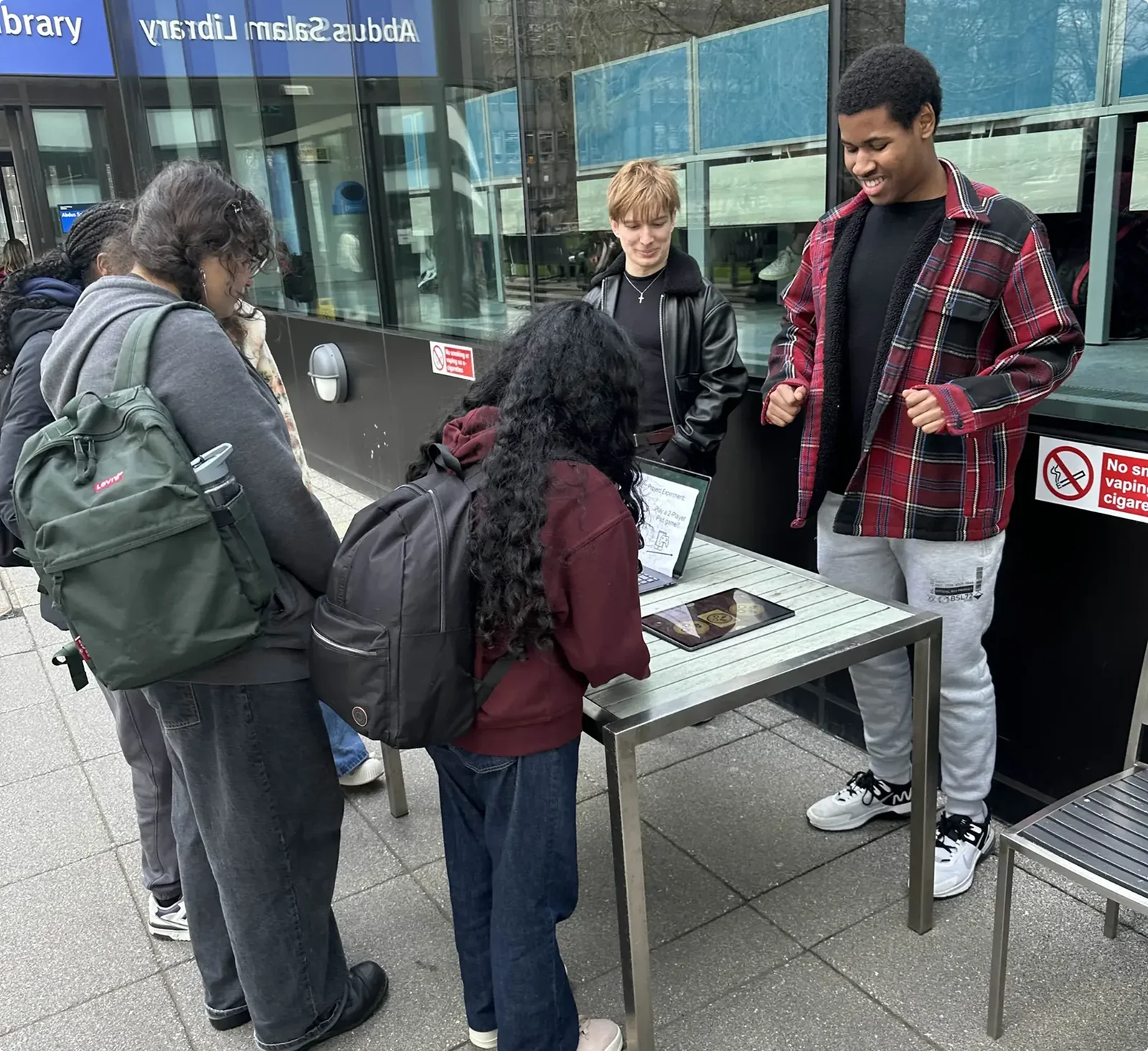 Passers-by stopping at our table outside the library